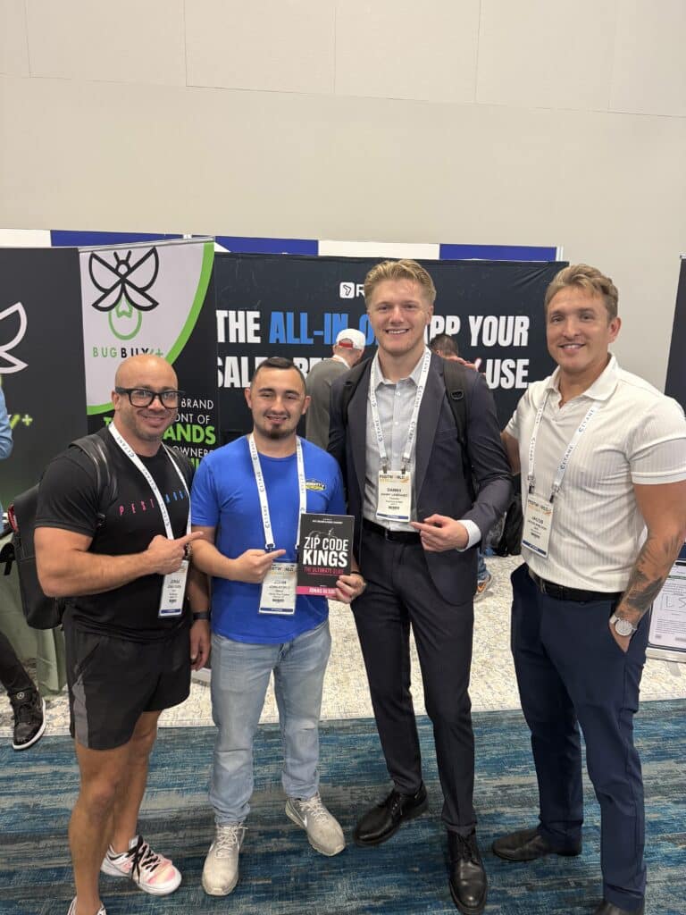 Pest Control Millionaires team and members gathered at the PestWorld 2025 booth with Zip Code Kings books