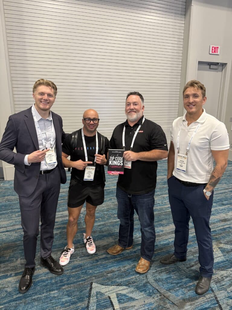 Pest control business owners holding copies of Zip Code Kings book together at PestWorld 2025