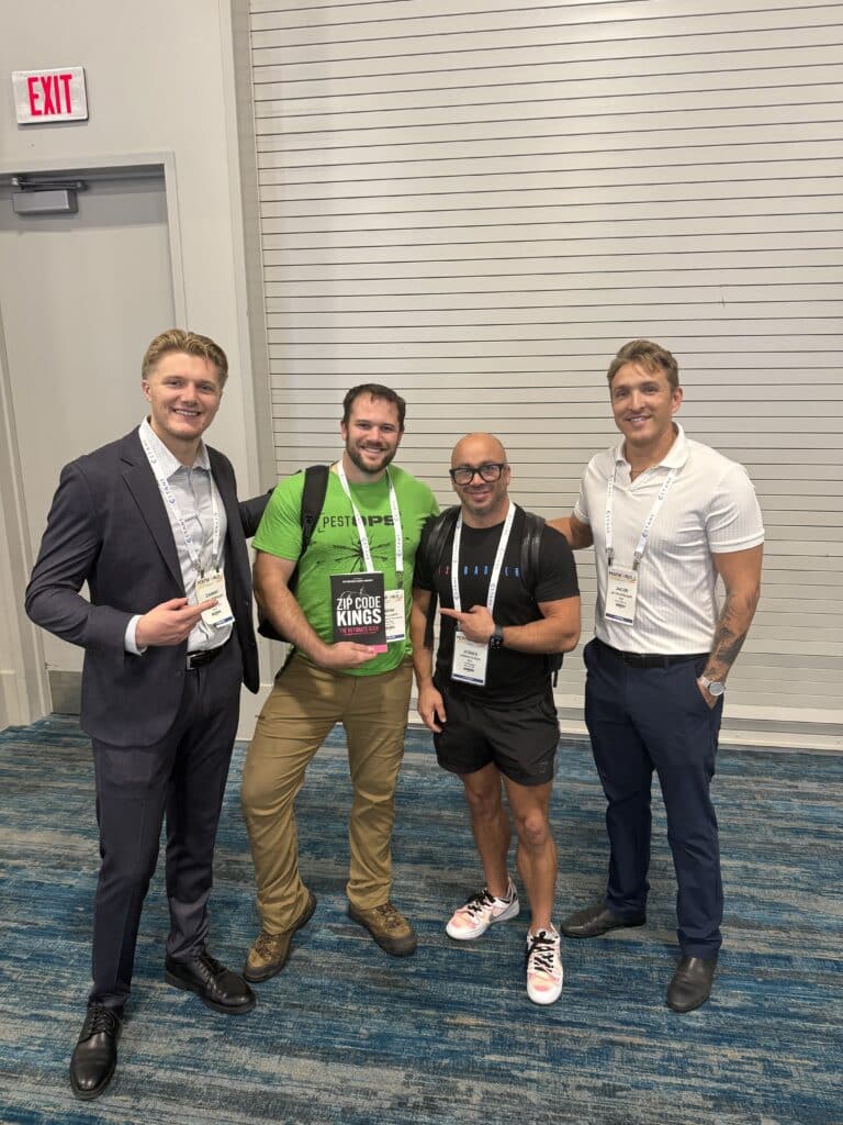 Pest control entrepreneurs browsing a copy of Zip Code Kings at the PestWorld 2025 trade show